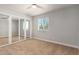 This bedroom features carpet floors, an open closet, window, and neutral paint at 2634 N 52Nd Ave, Phoenix, AZ 85035