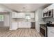 Modern kitchen boasting stainless steel appliances and bright white cabinetry at 2634 N 52Nd Ave, Phoenix, AZ 85035