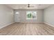 Bright living room featuring wood-look flooring and a large window at 2634 N 52Nd Ave, Phoenix, AZ 85035