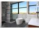 Modern bathroom with a freestanding tub, walk-in shower, and panoramic views of the desert landscape at 29218 N 107Th Way, Scottsdale, AZ 85262
