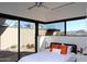 Modern bedroom featuring large windows with views, a ceiling fan, and minimalist decor at 29218 N 107Th Way, Scottsdale, AZ 85262