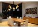Elegant dining room showcasing a unique live-edge wood table, stylish chandelier, and colorful wall art at 29218 N 107Th Way, Scottsdale, AZ 85262
