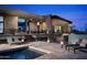 An outdoor view of a desert home with a private pool and multiple seating areas for entertaining and relaxation at 29218 N 107Th Way, Scottsdale, AZ 85262