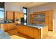 Bright kitchen featuring stainless steel appliances, a central island, light wood cabinets, and an adjacent dining area at 29218 N 107Th Way, Scottsdale, AZ 85262