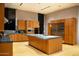 An open kitchen featuring custom wood cabinetry, a central island, modern stainless steel appliances, and ample counter space at 29218 N 107Th Way, Scottsdale, AZ 85262