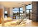 Sunlit living area featuring modern design, floor-to-ceiling windows with desert views, and a unique glass dining table at 29218 N 107Th Way, Scottsdale, AZ 85262