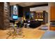 Open concept living room and dining area with stone accent walls, modern furnishings, and a stylish bar area at 29218 N 107Th Way, Scottsdale, AZ 85262