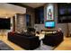 A spacious living room featuring a fireplace, piano, modern decor, and large windows offering picturesque outdoor views at 29218 N 107Th Way, Scottsdale, AZ 85262