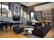 An open concept living room featuring large windows, modern décor, a fireplace, and stone accents for a sophisticated look at 29218 N 107Th Way, Scottsdale, AZ 85262