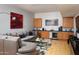 Relaxing living area with a large sectional sofa, wet bar, and modern finishes at 29218 N 107Th Way, Scottsdale, AZ 85262