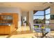 Bright, modern living space with wood floors, stainless steel appliances, and a large window overlooking a desert landscape at 29218 N 107Th Way, Scottsdale, AZ 85262