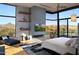 Serene main bedroom featuring expansive windows with desert views, fireplace, and modern decor at 29218 N 107Th Way, Scottsdale, AZ 85262