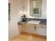 Modern powder room featuring a stone vessel sink, unique lighting, and a minimalist design at 29218 N 107Th Way, Scottsdale, AZ 85262