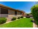 Well-maintained backyard with manicured lawn and a patio area perfect for outdoor entertaining at 29374 N 68Th Ln, Peoria, AZ 85383