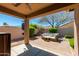 Inviting backyard patio with a comfortable seating area and lush landscaping at 29374 N 68Th Ln, Peoria, AZ 85383