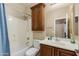 Functional bathroom layout featuring a vanity, toilet, and a shower-tub combination at 29374 N 68Th Ln, Peoria, AZ 85383