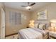Well-lit bedroom featuring a plush bed, neutral decor, and a ceiling fan at 29374 N 68Th Ln, Peoria, AZ 85383