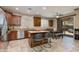 Modern kitchen with granite countertops, stainless steel appliances, and breakfast bar at 29374 N 68Th Ln, Peoria, AZ 85383