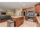 Kitchen featuring stainless steel appliances, granite countertops, and an island next to a living area at 29374 N 68Th Ln, Peoria, AZ 85383