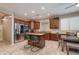 Spacious kitchen featuring stainless steel appliances, wooden cabinetry, and a center island with bar seating at 29374 N 68Th Ln, Peoria, AZ 85383