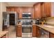 Close-up of kitchen with stainless steel appliances, granite countertops, and wooden cabinets at 29374 N 68Th Ln, Peoria, AZ 85383