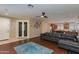 Open-concept living area blends seamlessly with kitchen; features a ceiling fan and ample light at 29374 N 68Th Ln, Peoria, AZ 85383
