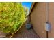 Functional side yard with gravel, an AC unit, and mature landscaping at 29374 N 68Th Ln, Peoria, AZ 85383