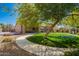 Spacious backyard featuring lush lawn, mature trees, and a basketball court for outdoor fun and relaxation at 3046 E Athena Ave, Gilbert, AZ 85297
