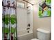 This bathroom offers a shower and tub, with a fun monkey shower curtain and matching monkey wall art at 3046 E Athena Ave, Gilbert, AZ 85297
