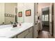 Bathroom featuring a single sink vanity and an open doorway to the dining area at 3046 E Athena Ave, Gilbert, AZ 85297