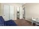 Comfortable bedroom with a glimpse into the bathroom and featuring ample closet space for storage at 3046 E Athena Ave, Gilbert, AZ 85297