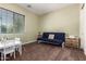 Cozy bedroom showcasing neutral walls, a large window, and a comfortable futon, creating a relaxing space at 3046 E Athena Ave, Gilbert, AZ 85297