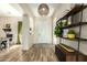 Bright foyer featuring hardwood floors, stylish lighting, and decorative shelving at 3046 E Athena Ave, Gilbert, AZ 85297