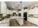 Spacious kitchen featuring white cabinets, granite countertops, and a large center island at 3046 E Athena Ave, Gilbert, AZ 85297