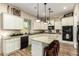 Wide shot of the kitchen with granite countertops, white cabinetry, and stainless steel appliances at 3046 E Athena Ave, Gilbert, AZ 85297