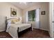 Inviting primary bedroom features warm colors, a comfortable bed, and a window for plenty of natural light at 3046 E Athena Ave, Gilbert, AZ 85297