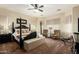 Main bedroom featuring a four-poster bed, sitting area, and soft, neutral tones at 3046 E Athena Ave, Gilbert, AZ 85297