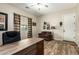Functional home office featuring wood-look floors, natural lighting, and comfortable seating at 3046 E Athena Ave, Gilbert, AZ 85297