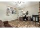 Well-lit home office with ample desk space, featuring wood-look floors, and convenient storage at 3046 E Athena Ave, Gilbert, AZ 85297