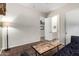 Spacious room with a modern table, door to the bathroom, and black couch at 3046 E Athena Ave, Gilbert, AZ 85297