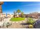 Spacious backyard with a desert landscape, artificial grass, stone features, and patio seating for outdoor enjoyment at 31013 N Claridge Cir, San Tan Valley, AZ 85143