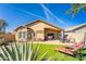 Inviting backyard featuring artificial grass, patio furniture, and a well-maintained landscape, ideal for outdoor relaxation at 31013 N Claridge Cir, San Tan Valley, AZ 85143