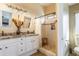 Bright bathroom with double vanity, granite countertops, and a tiled walk-in shower for a luxurious and modern feel at 31013 N Claridge Cir, San Tan Valley, AZ 85143
