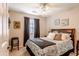 Comfortable bedroom with a ceiling fan, large window, dark curtains, and queen size bed at 31013 N Claridge Cir, San Tan Valley, AZ 85143