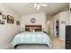 Well-lit main bedroom with neutral walls, ceiling fan, and a large bed, creating a serene and inviting atmosphere at 31013 N Claridge Cir, San Tan Valley, AZ 85143