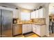 Updated kitchen featuring stainless steel appliances, tile backsplash, granite countertops, and ample cabinet space at 31013 N Claridge Cir, San Tan Valley, AZ 85143