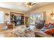 Spacious living room featuring tile floors, a fireplace, comfortable seating, and sliding glass doors to the patio at 31013 N Claridge Cir, San Tan Valley, AZ 85143