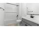 Well-lit bathroom with modern gray vanity, white subway tile in the shower, and contemporary black fixtures at 37650 W Nina St, Maricopa, AZ 85138