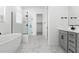 Bright bathroom with walk-in shower, soaker tub, and double vanity sinks at 37650 W Nina St, Maricopa, AZ 85138