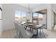 Dining area showcasing a table set with plates, glasses, and comfortable seating at 37650 W Nina St, Maricopa, AZ 85138